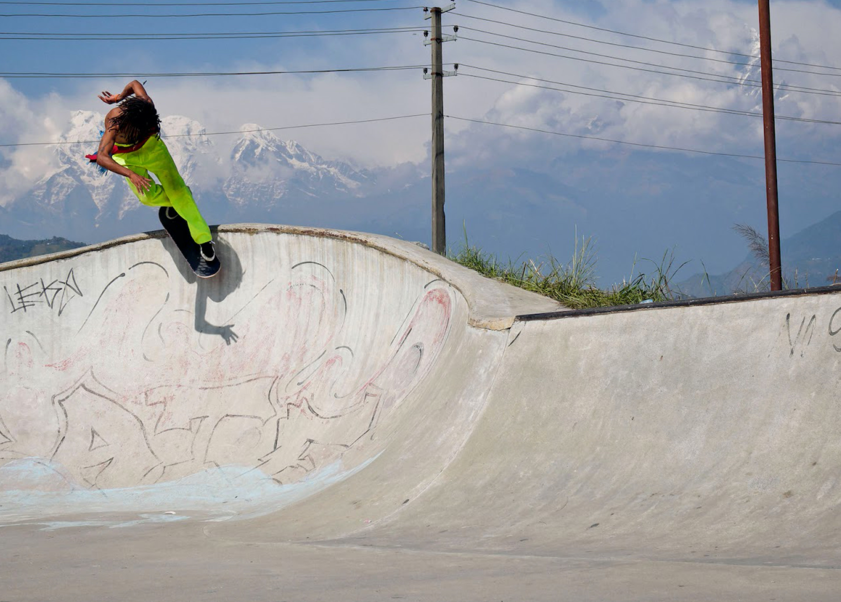 A skateboarder skateboarding on a ramp in Nepal.
